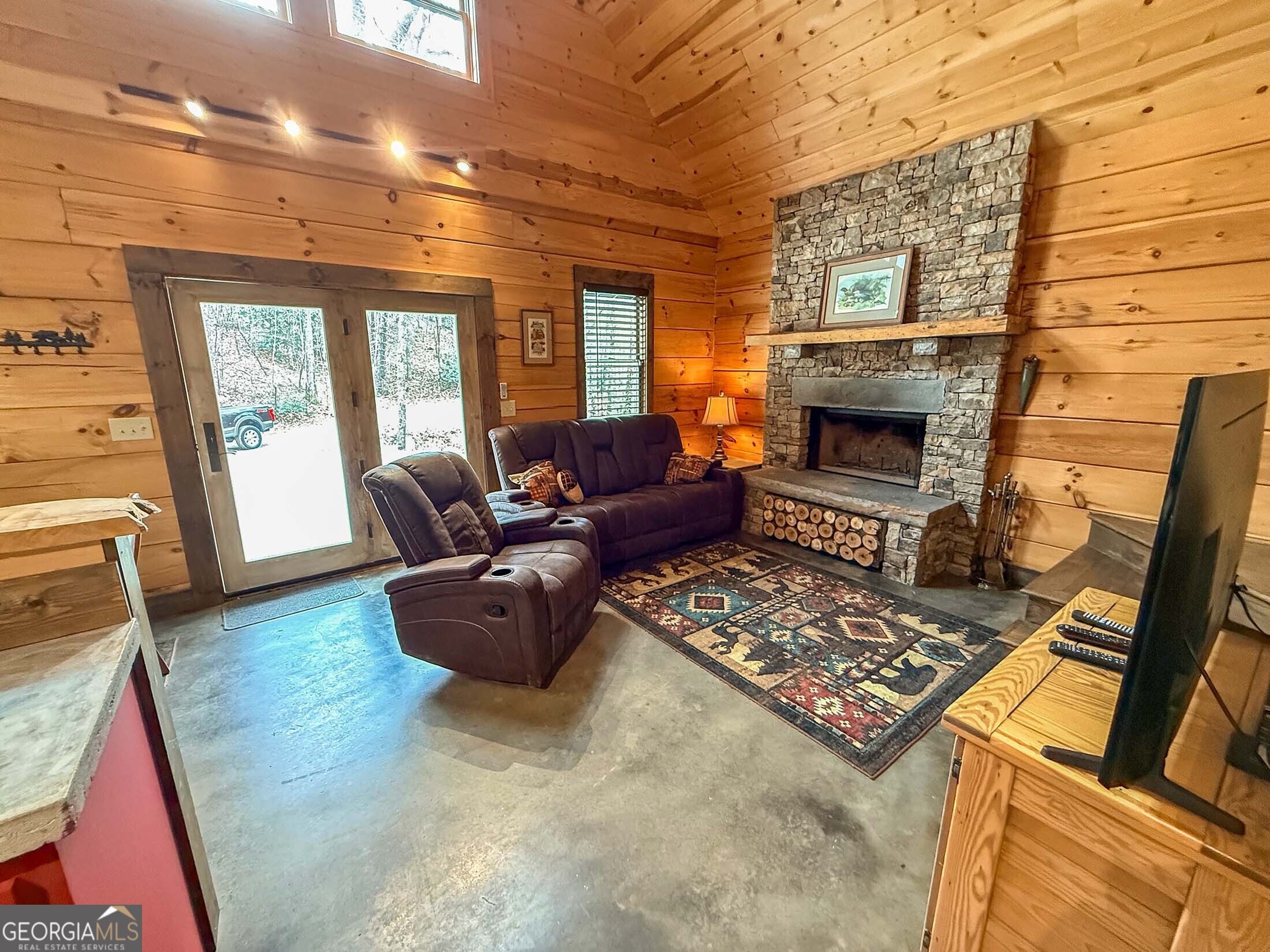 513 Coleman Heights Lane Rabun Gap, GA 30568 - Photo 24 of 36 a living room with furniture and a fireplace