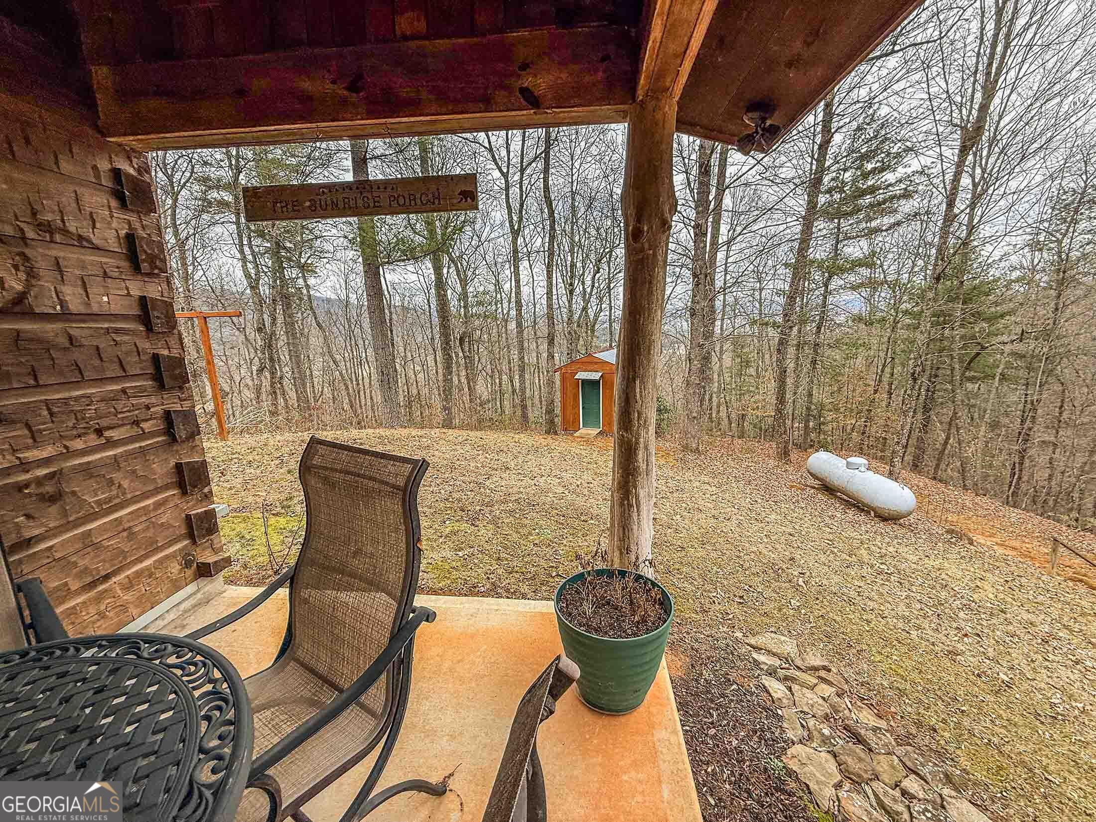 513 Coleman Heights Lane Rabun Gap, GA 30568 - Photo 32 of 36 a view of a patio with table and chairs and potted plants