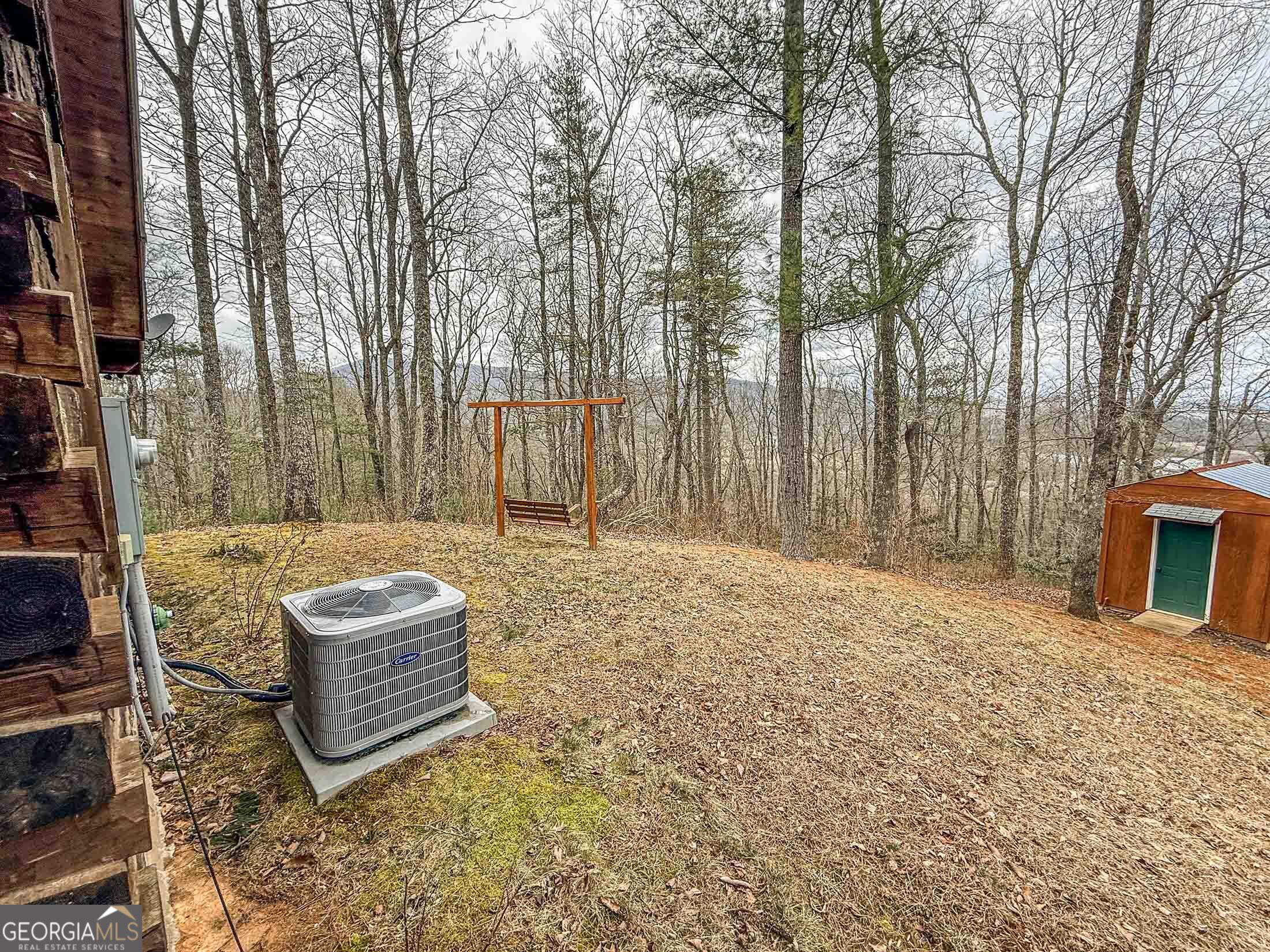 513 Coleman Heights Lane Rabun Gap, GA 30568 - Photo 34 of 36 a backyard of a house with sofas fire pit and large trees