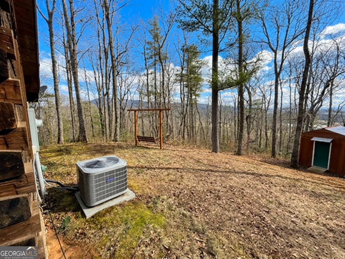 513 Coleman Heights Lane Rabun Gap, GA 30568 - Photo 7 of 36 a backyard of a house with barbeque oven and outdoor seating