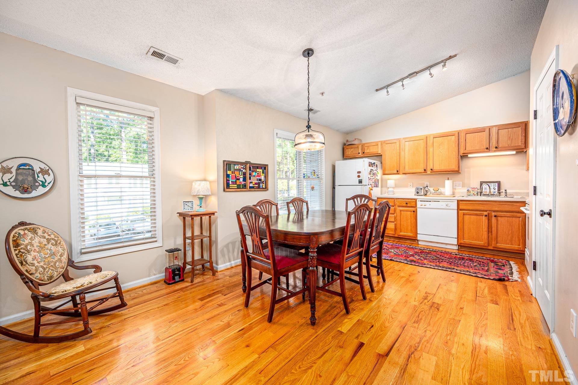 121 Westview Drive, Unit 36 Carrboro, NC 27510 - Photo 1 of 32 a view of a dining room with furniture window and wooden floor