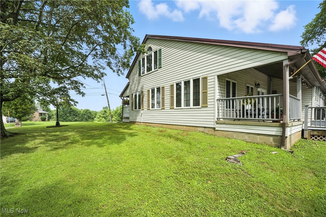 1371 Spider Ridge Road Parkersburg, WV 26104 - Photo 36 of 48 View of side of property featuring a yard and covered porch