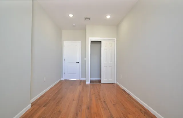 a view of hallway with wooden floor