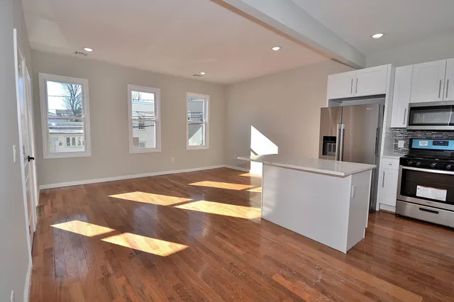 a view of kitchen and wooden floor