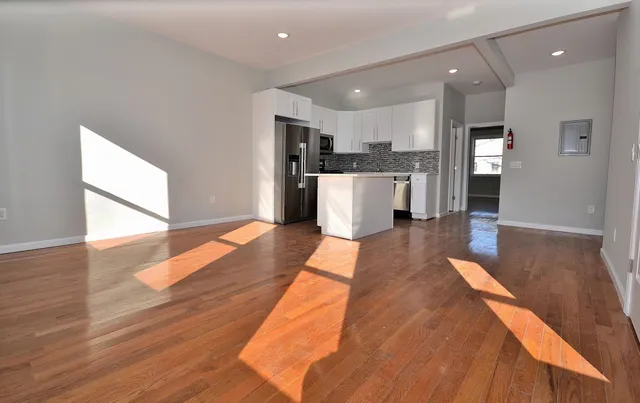 a view of kitchen with cabinets and wooden floor