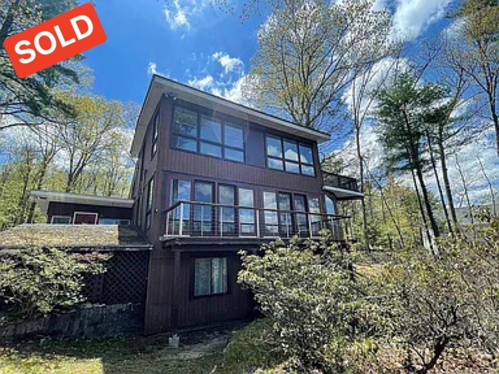 a view of a brick house with a yard