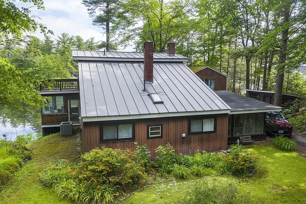 84 Hemlock Drive Lunenburg, MA 01462 - Photo 2 of 2 a view of a house with a yard plants and large tree