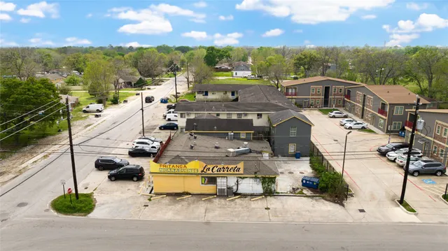 a view of a patio with dining table and chairs