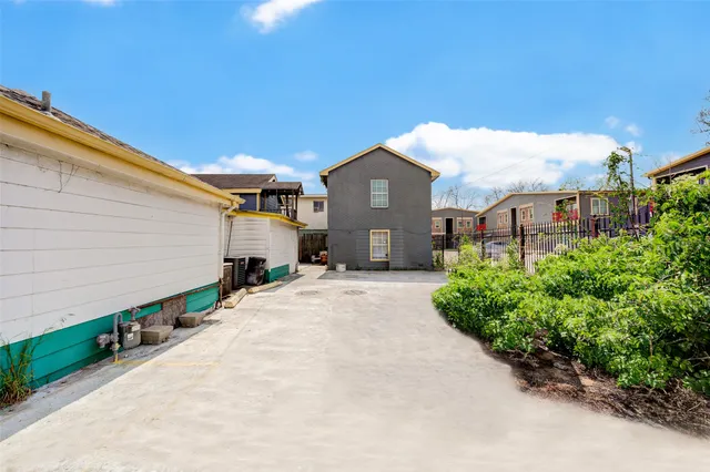 a view of a house with large windows and a small yard