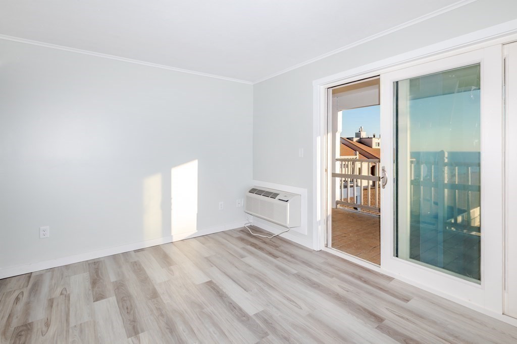 449 Ocean Boulevard, Unit 305 Hampton, NH 03842 - Photo 13 of 28 an empty room with windows and entrance