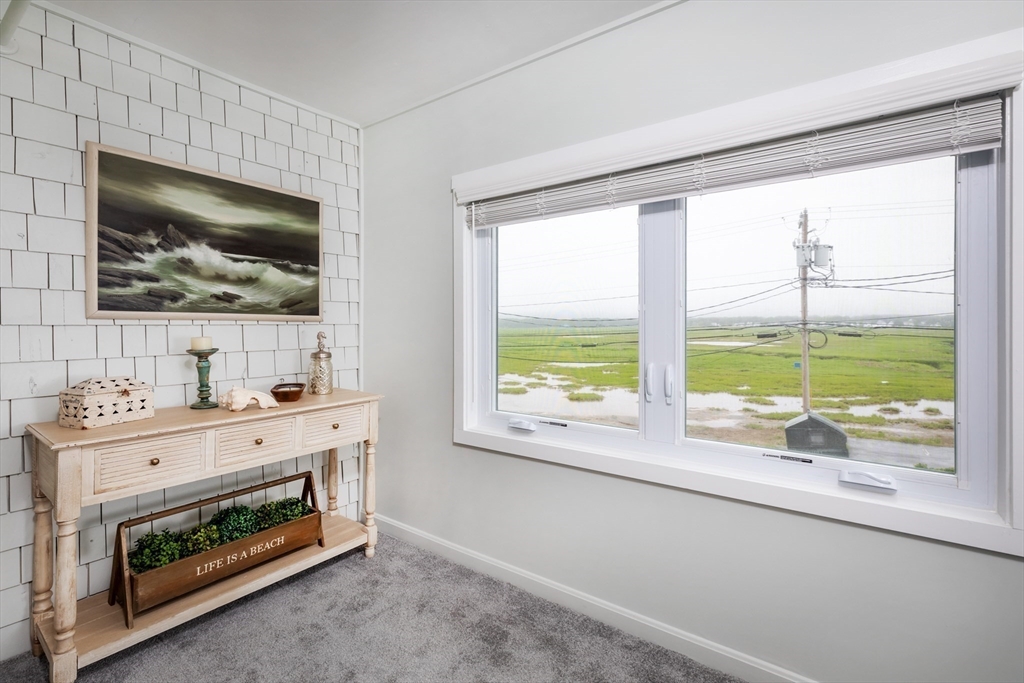 449 Ocean Boulevard, Unit 305 Hampton, NH 03842 - Photo 20 of 28 a room with furniture and flat screen tv