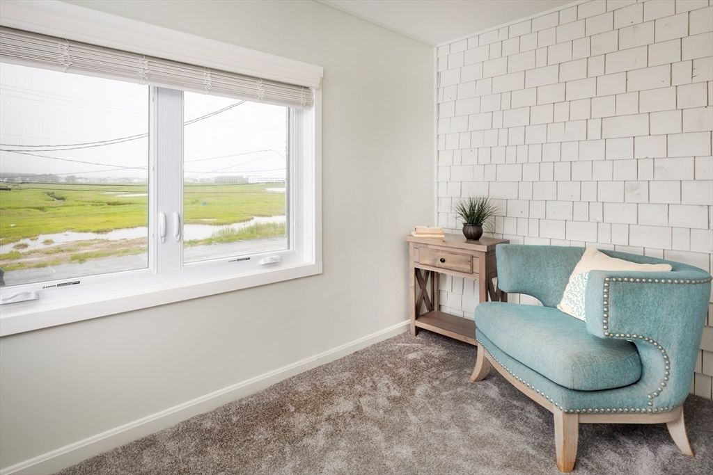 449 Ocean Boulevard, Unit 305 Hampton, NH 03842 - Photo 21 of 28 a living room with furniture and a window