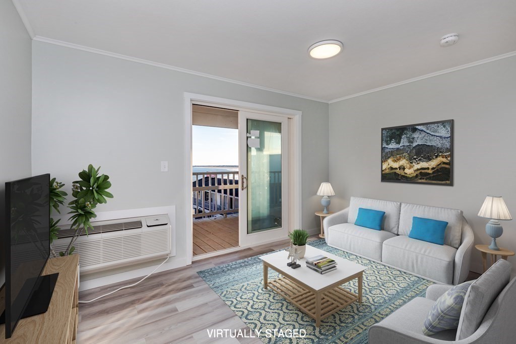 449 Ocean Boulevard, Unit 305 Hampton, NH 03842 - Photo 6 of 28 a living room with furniture and a rug