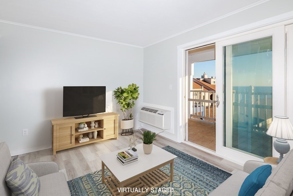 449 Ocean Boulevard, Unit 305 Hampton, NH 03842 - Photo 10 of 28 a living room with furniture and a flat screen tv