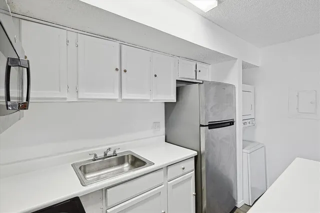 a kitchen with stainless steel appliances white cabinets and white appliances