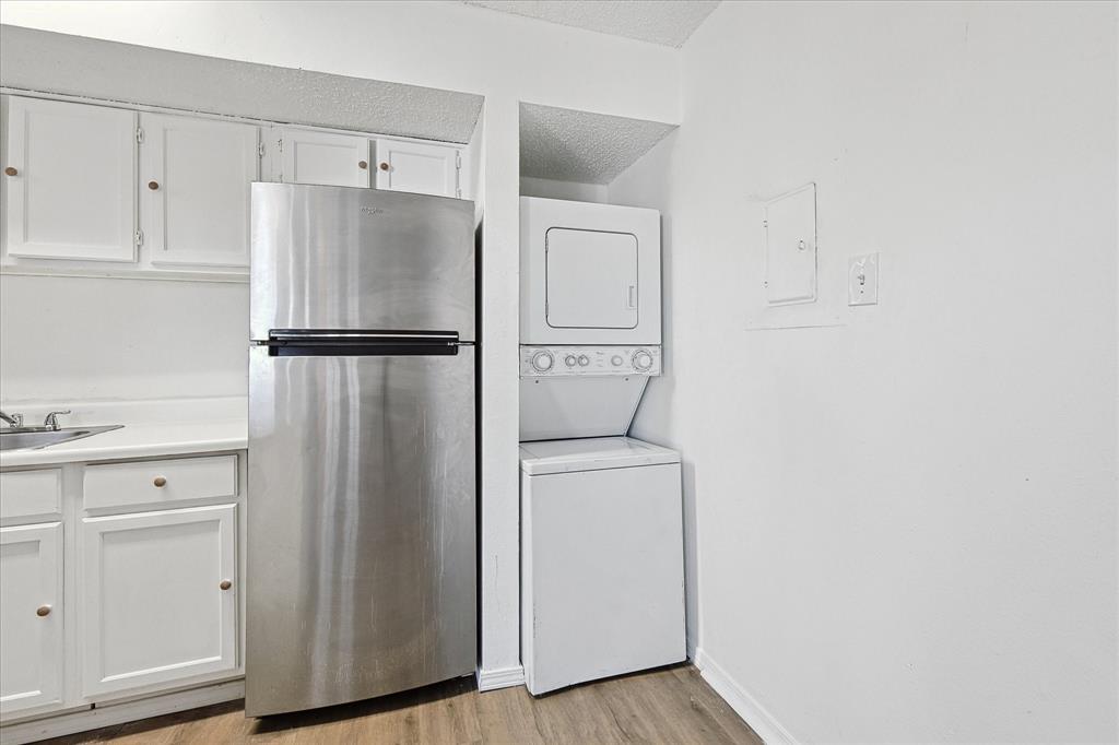 9839 Walnut Street, Unit 306 Dallas, TX 75243 - Photo 13 of 32 a white refrigerator freezer and cabinets in a white cabinet