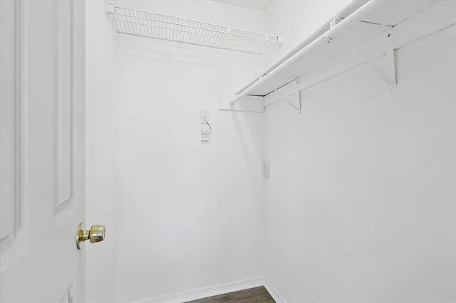 a bathroom with a toilet sink vanity and mirror