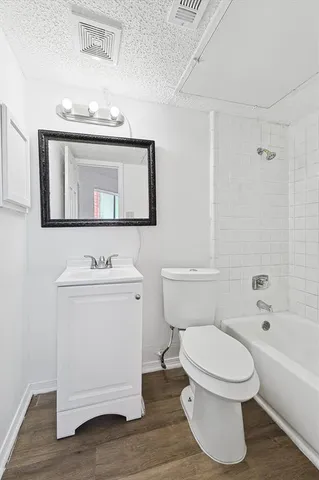 a bathroom with a toilet a sink and bathtub