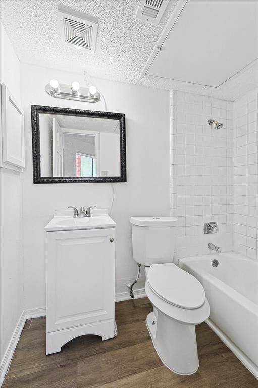 9839 Walnut Street, Unit 306 Dallas, TX 75243 - Photo 17 of 32 a bathroom with a toilet a sink and bathtub