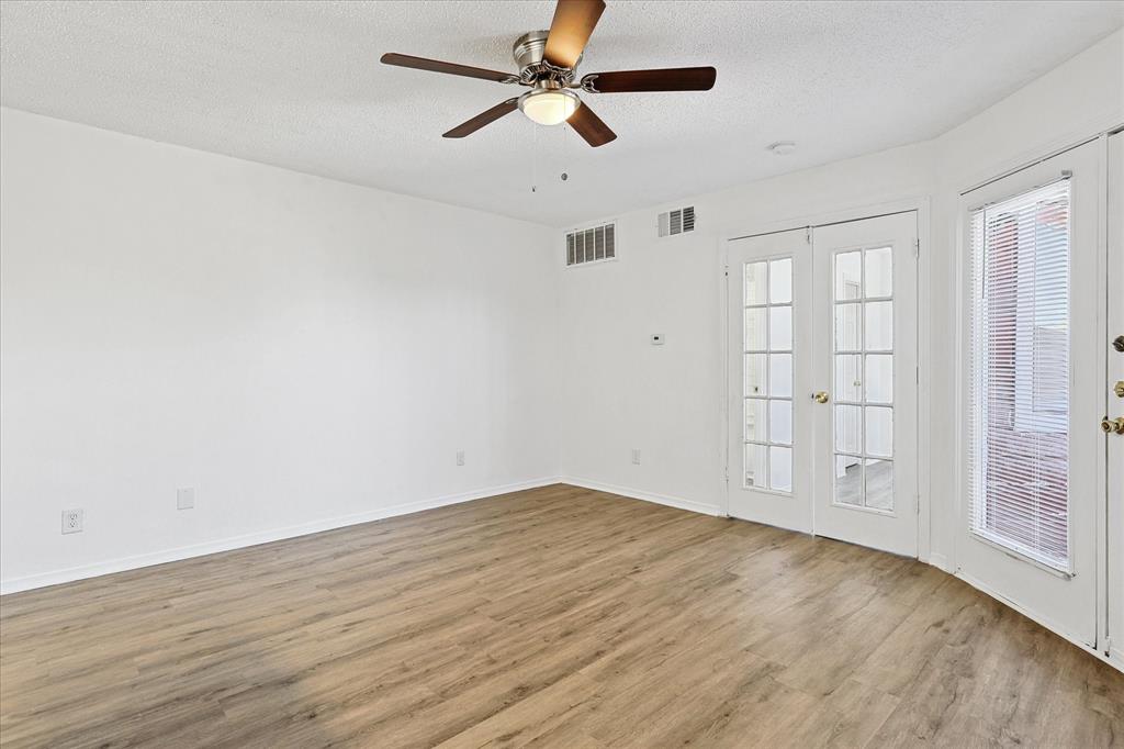 9839 Walnut Street, Unit 306 Dallas, TX 75243 - Photo 24 of 32 wooden floor in an empty room with a window