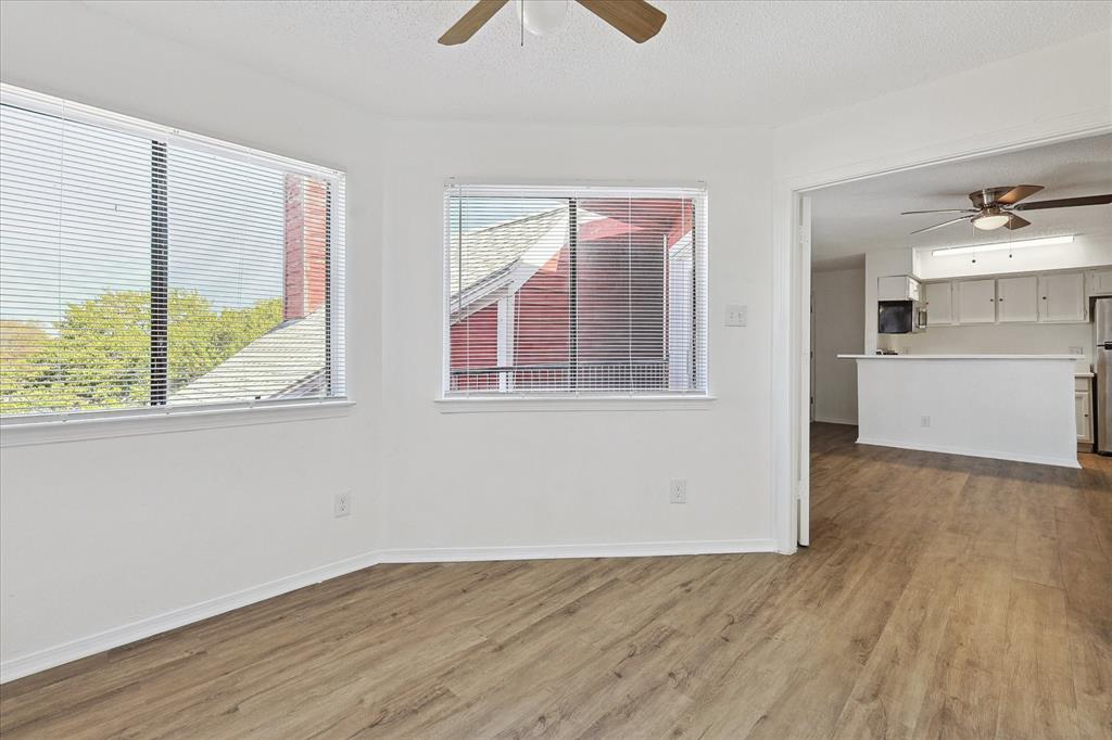 9839 Walnut Street, Unit 306 Dallas, TX 75243 - Photo 10 of 32 a view of empty room with wooden floor and fan