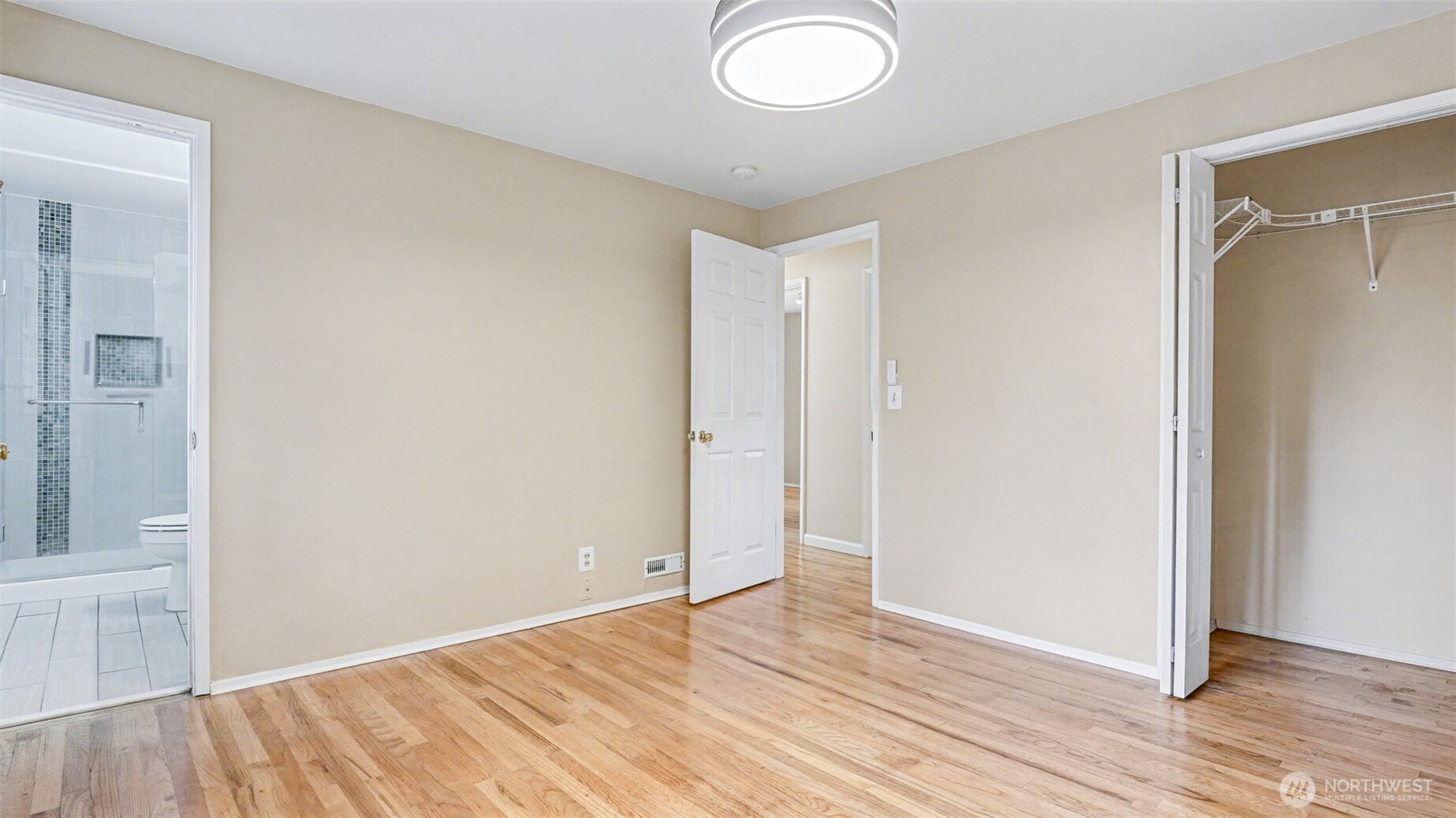 6201 Island Crest Way Mercer Island, WA 98040 - Photo 17 of 40 an empty room with wooden floor and windows