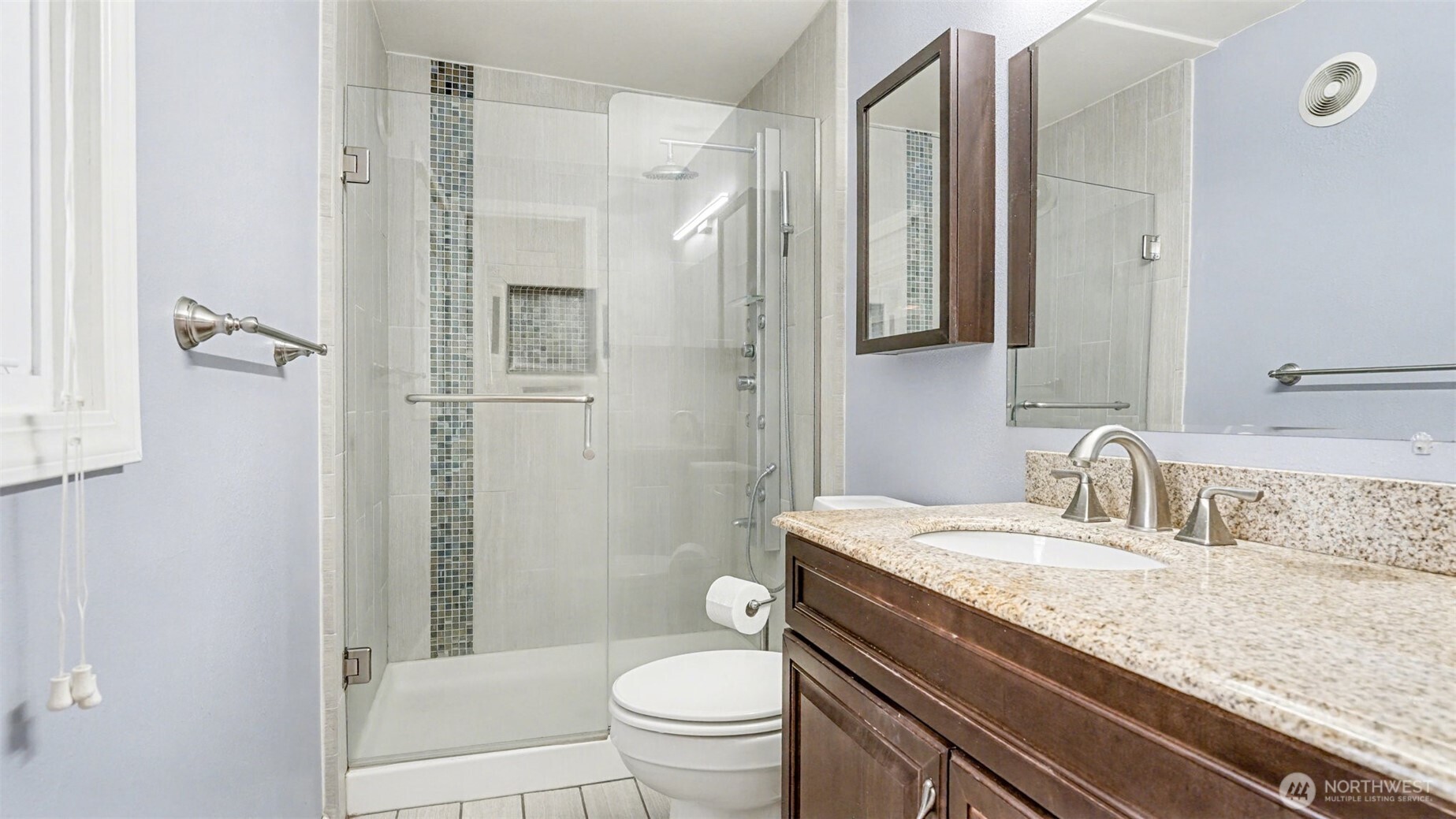 6201 Island Crest Way Mercer Island, WA 98040 - Photo 18 of 40 a bathroom with a granite countertop sink toilet and shower