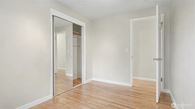a view of a room with wooden floor