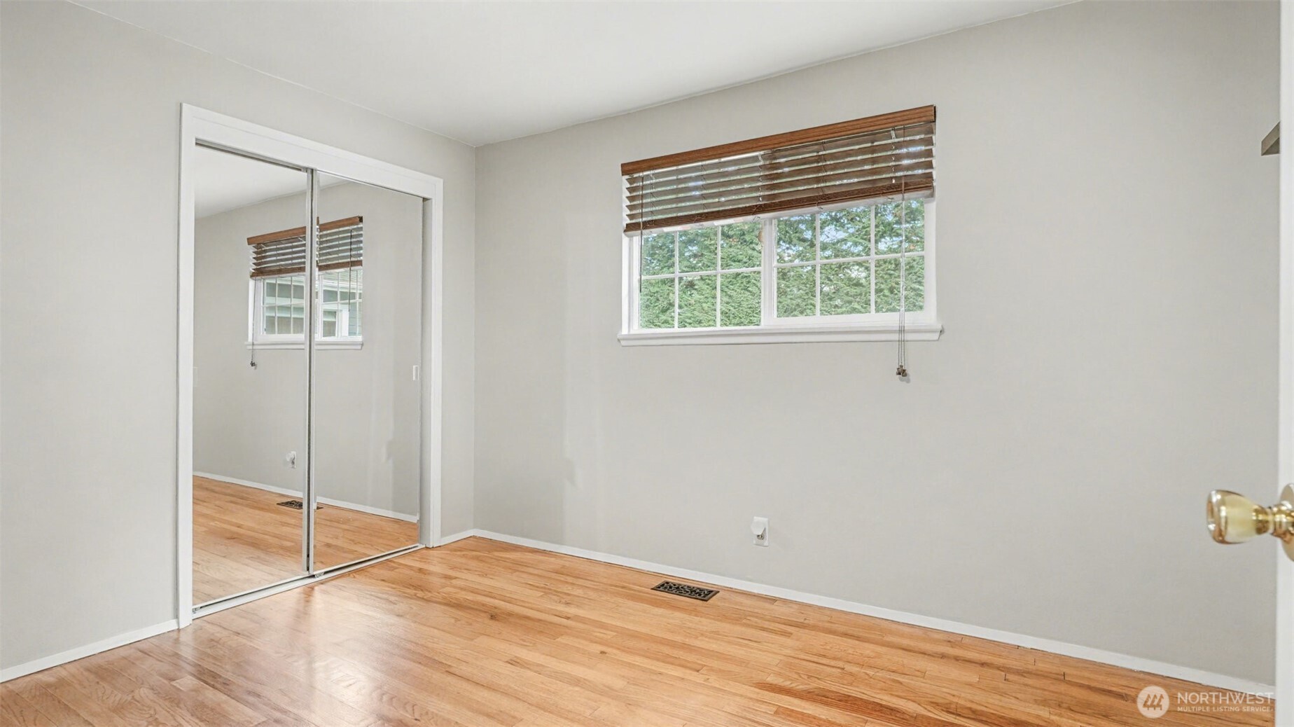 6201 Island Crest Way Mercer Island, WA 98040 - Photo 23 of 40 a view of empty room with wooden floor and fan