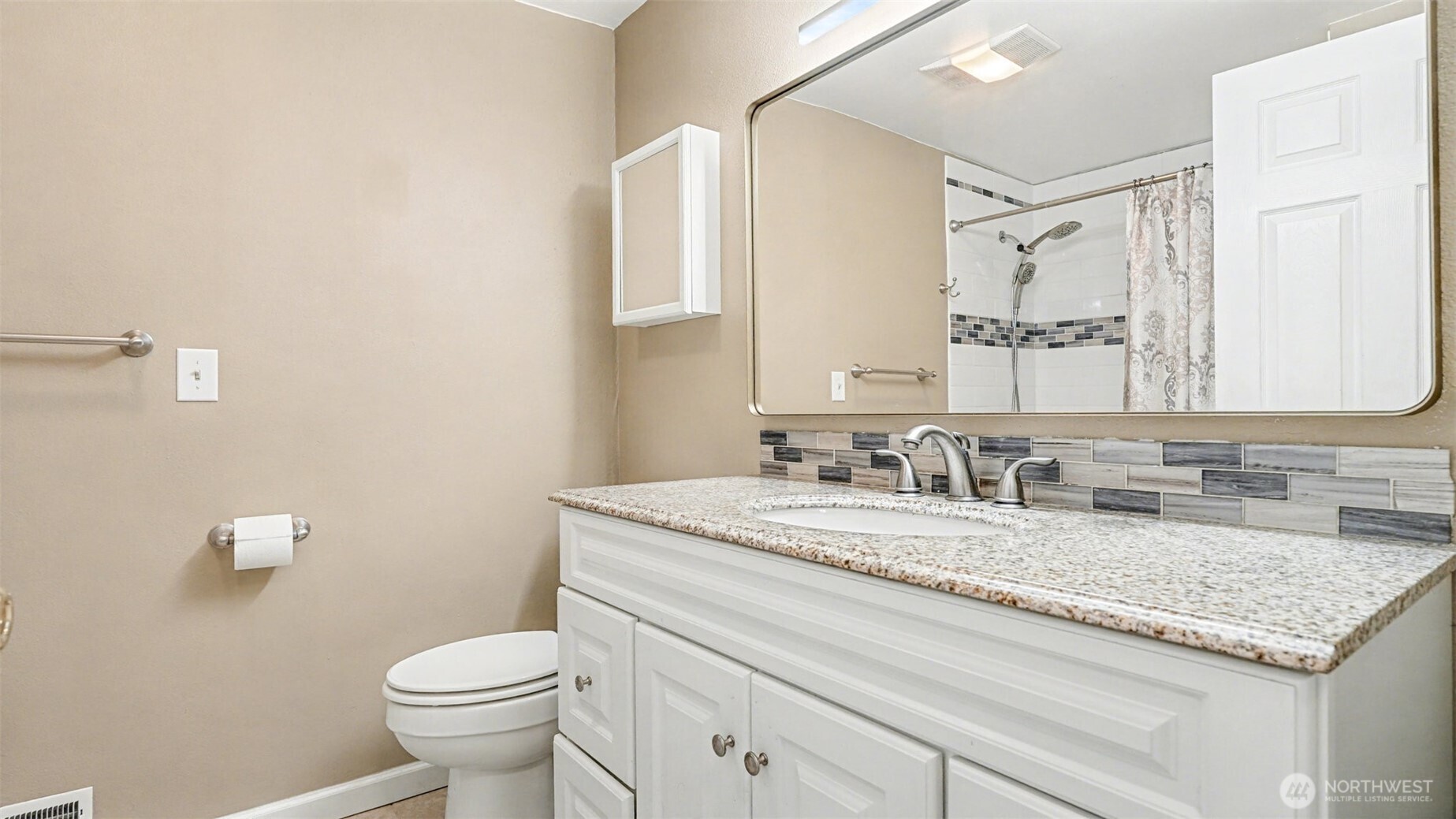 6201 Island Crest Way Mercer Island, WA 98040 - Photo 24 of 40 a bathroom with a granite countertop sink vanity mirror and toilet