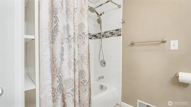 a bathroom with a shower and a tub