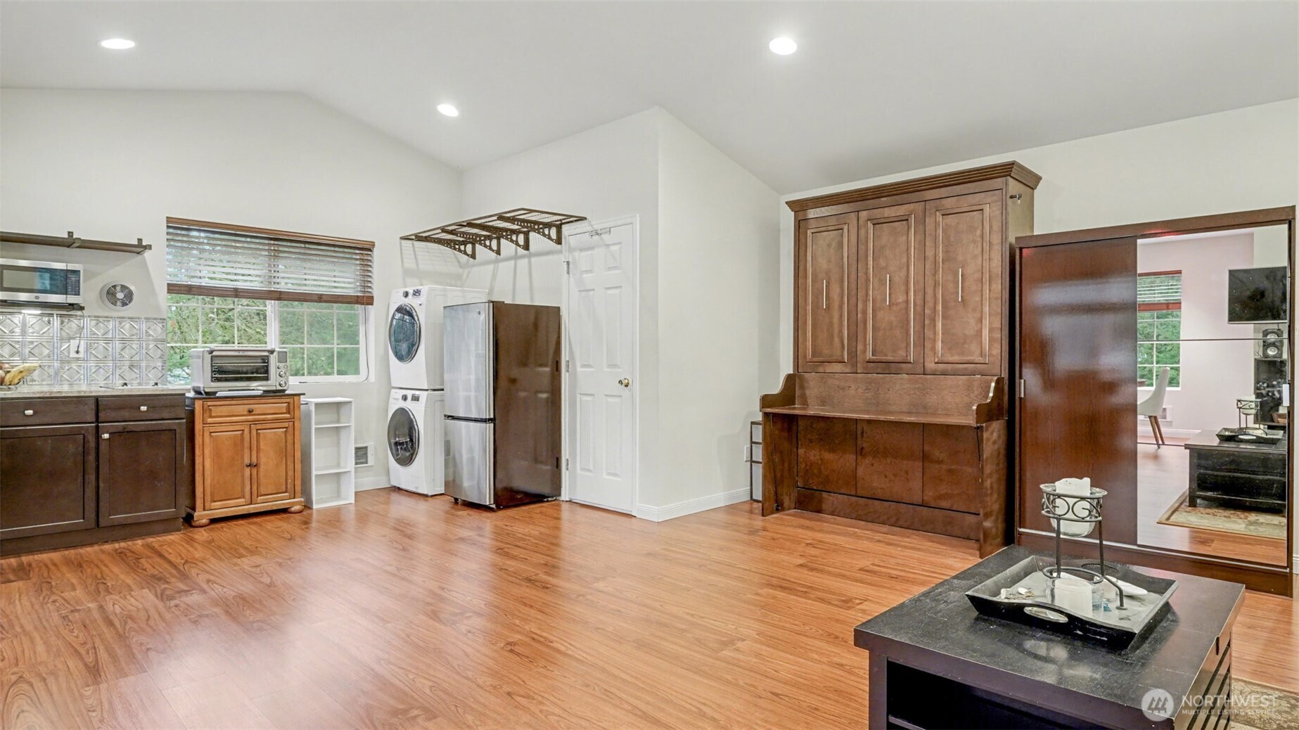 6201 Island Crest Way Mercer Island, WA 98040 - Photo 27 of 40 a kitchen with stainless steel appliances kitchen island granite countertop a refrigerator a sink a stove and white cabinets with wooden floor