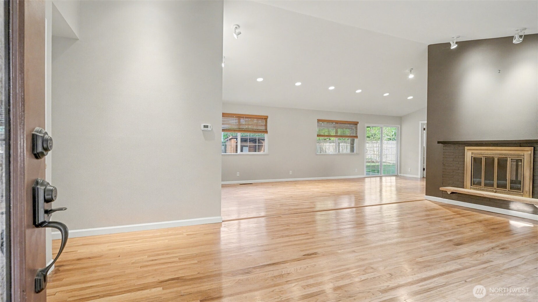6201 Island Crest Way Mercer Island, WA 98040 - Photo 4 of 40 a view of an empty room with wooden floor and a window