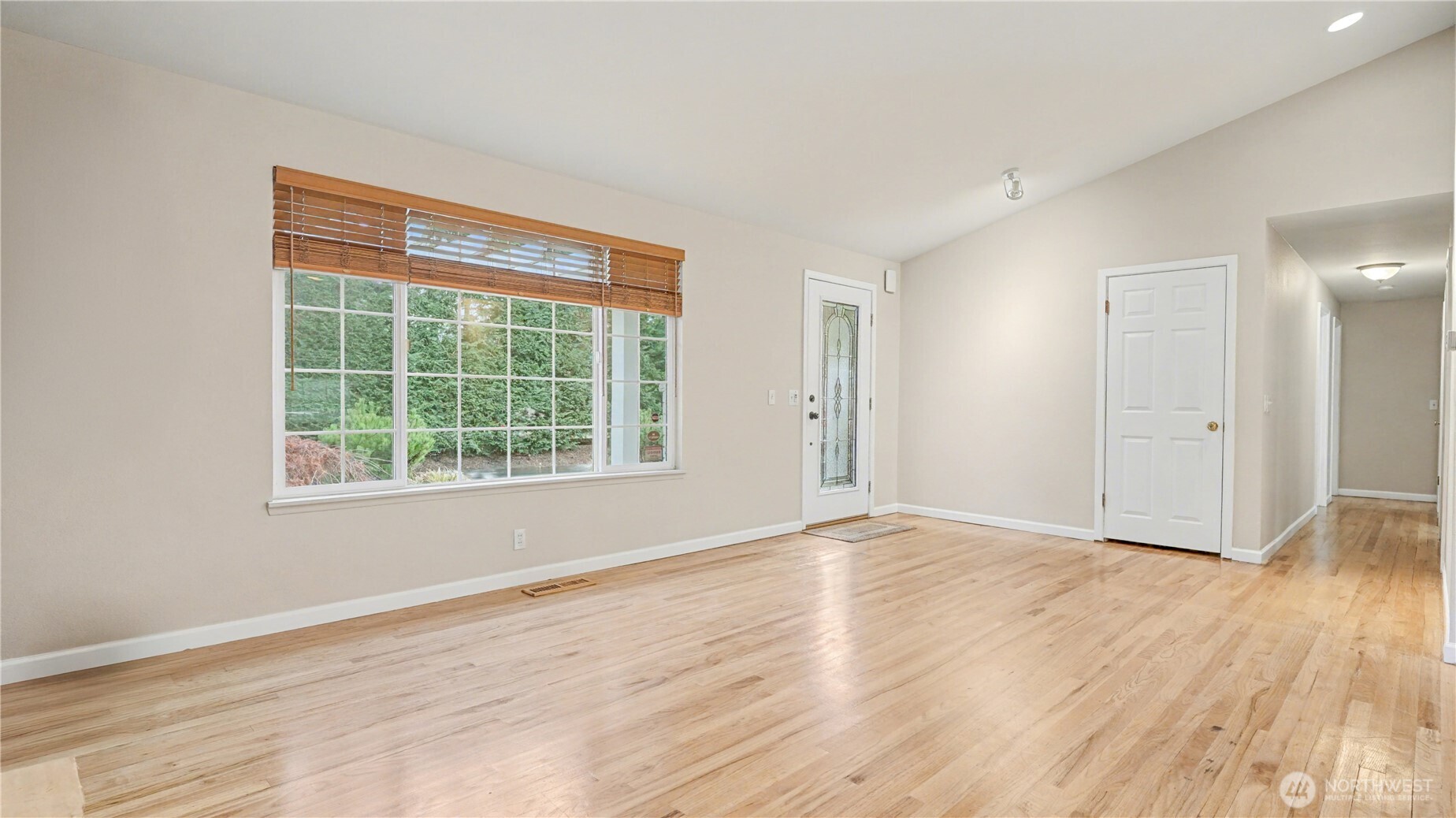 6201 Island Crest Way Mercer Island, WA 98040 - Photo 6 of 40 a view of an empty room with wooden floor and a window