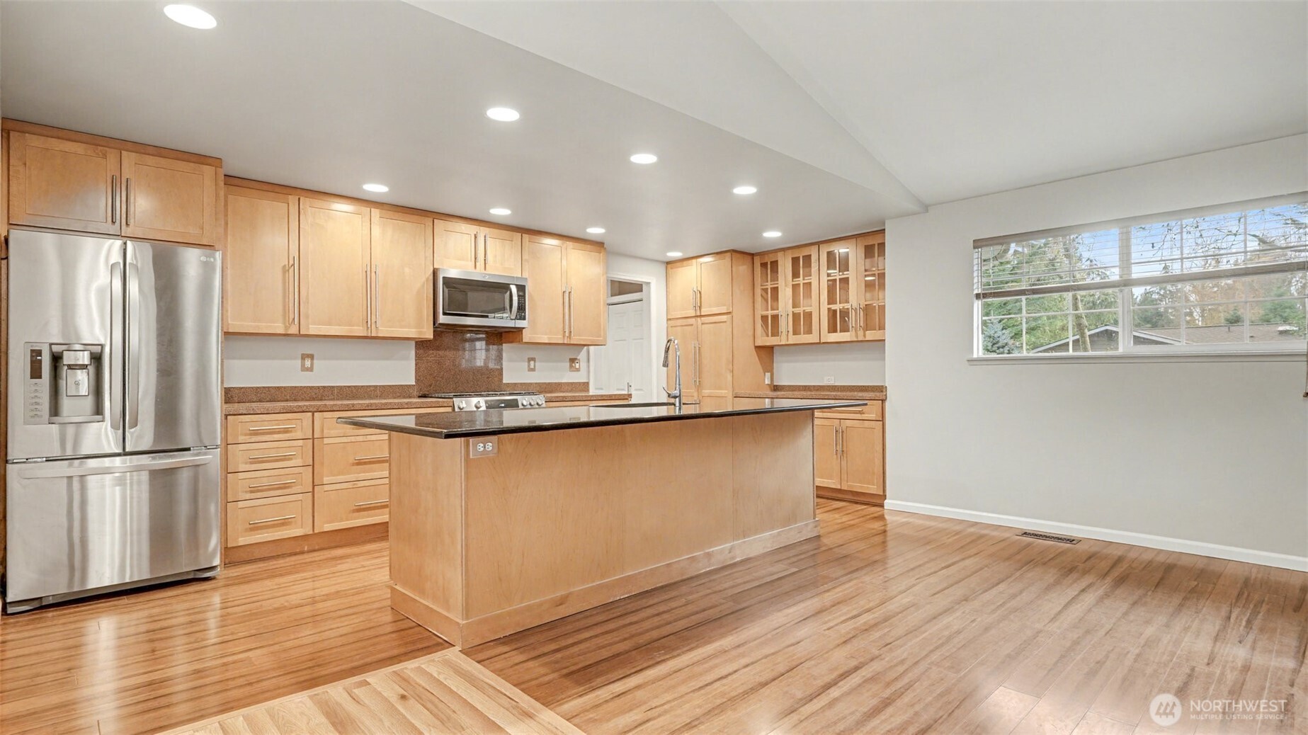 6201 Island Crest Way Mercer Island, WA 98040 - Photo 9 of 40 a kitchen with granite countertop a refrigerator and a stove top oven