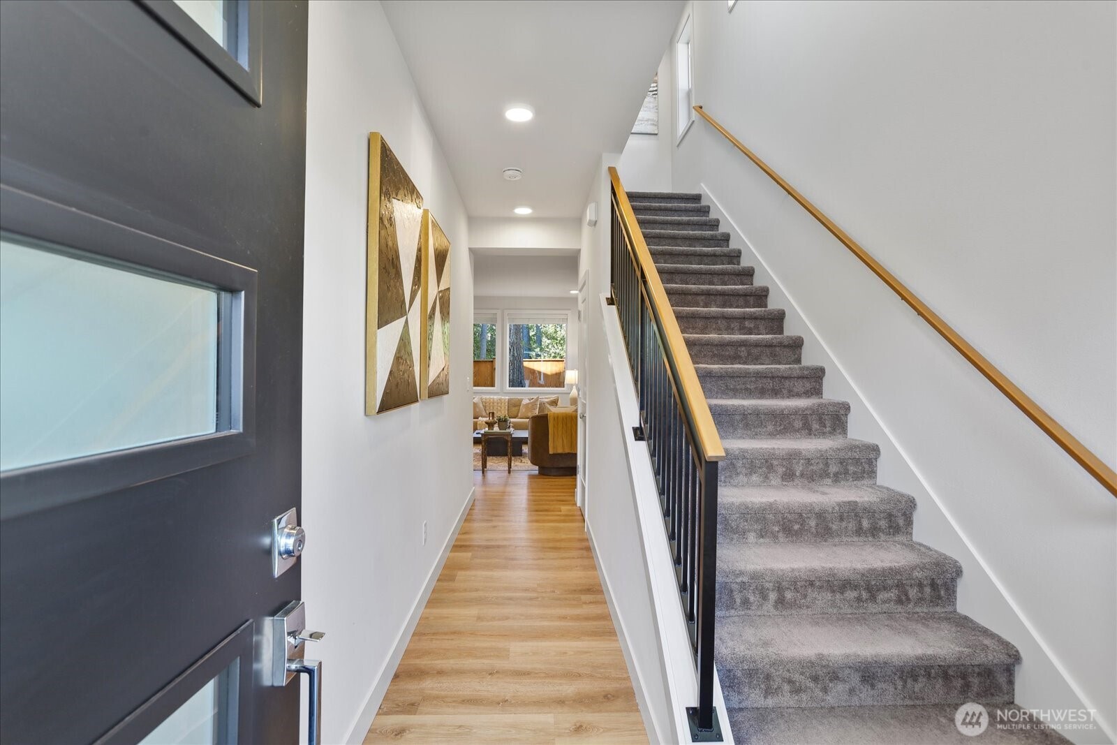 121 171st Place Southwest, Unit B Bothell, WA 98012 - Photo 3 of 36 a view of a hallway with wooden floor and stairs