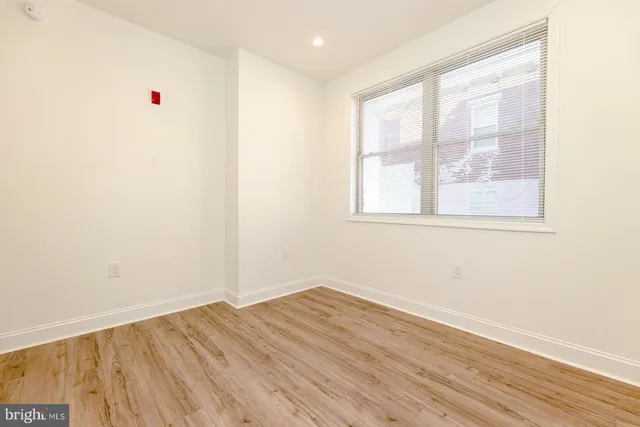a view of a room with wooden floor and white doors