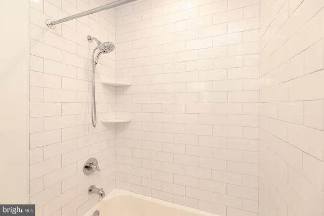 a kitchen with kitchen island wooden floors appliances and cabinets
