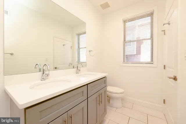 a kitchen with a refrigerator sink and cabinets
