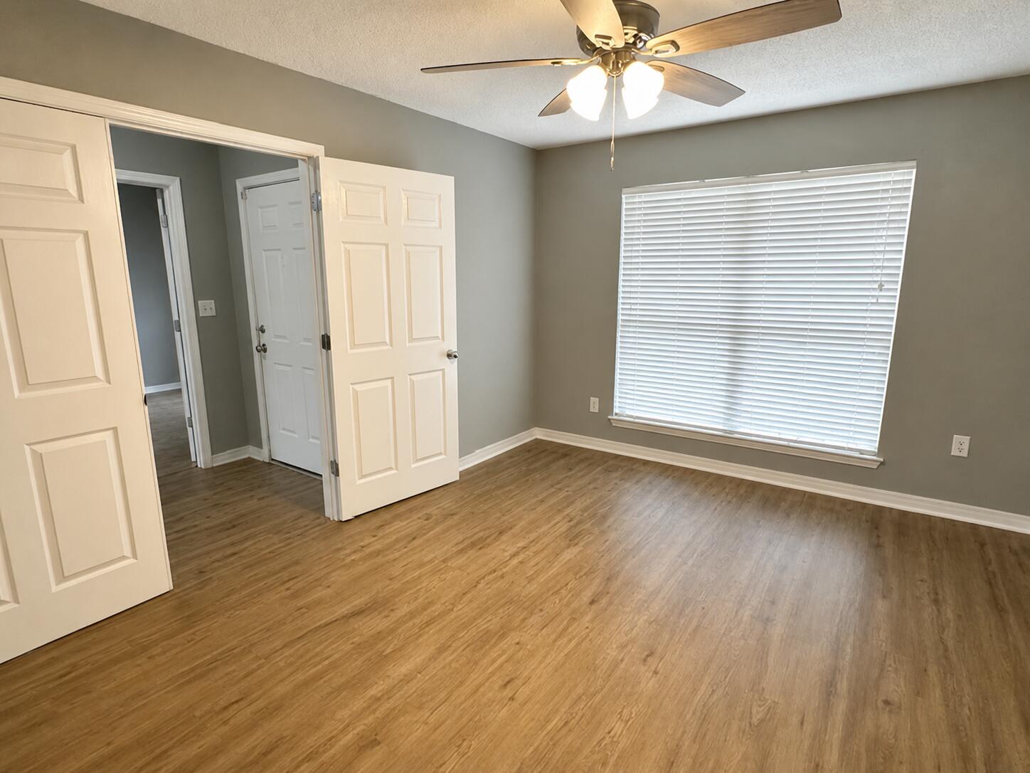 2155 Hagood Loop Crestview, FL 32536 - Photo 3 of 16 an empty room with wooden floor fan and windows