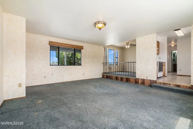 a view of a room with gym equipment and a window