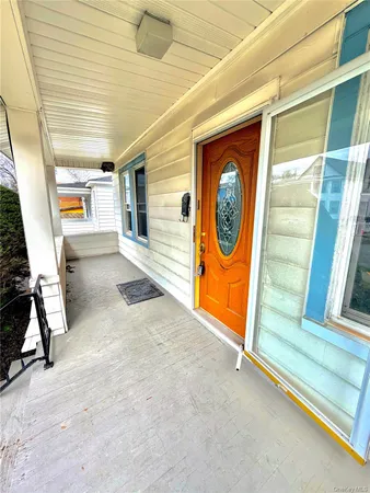 a view of a big room with windows and chandelier fan