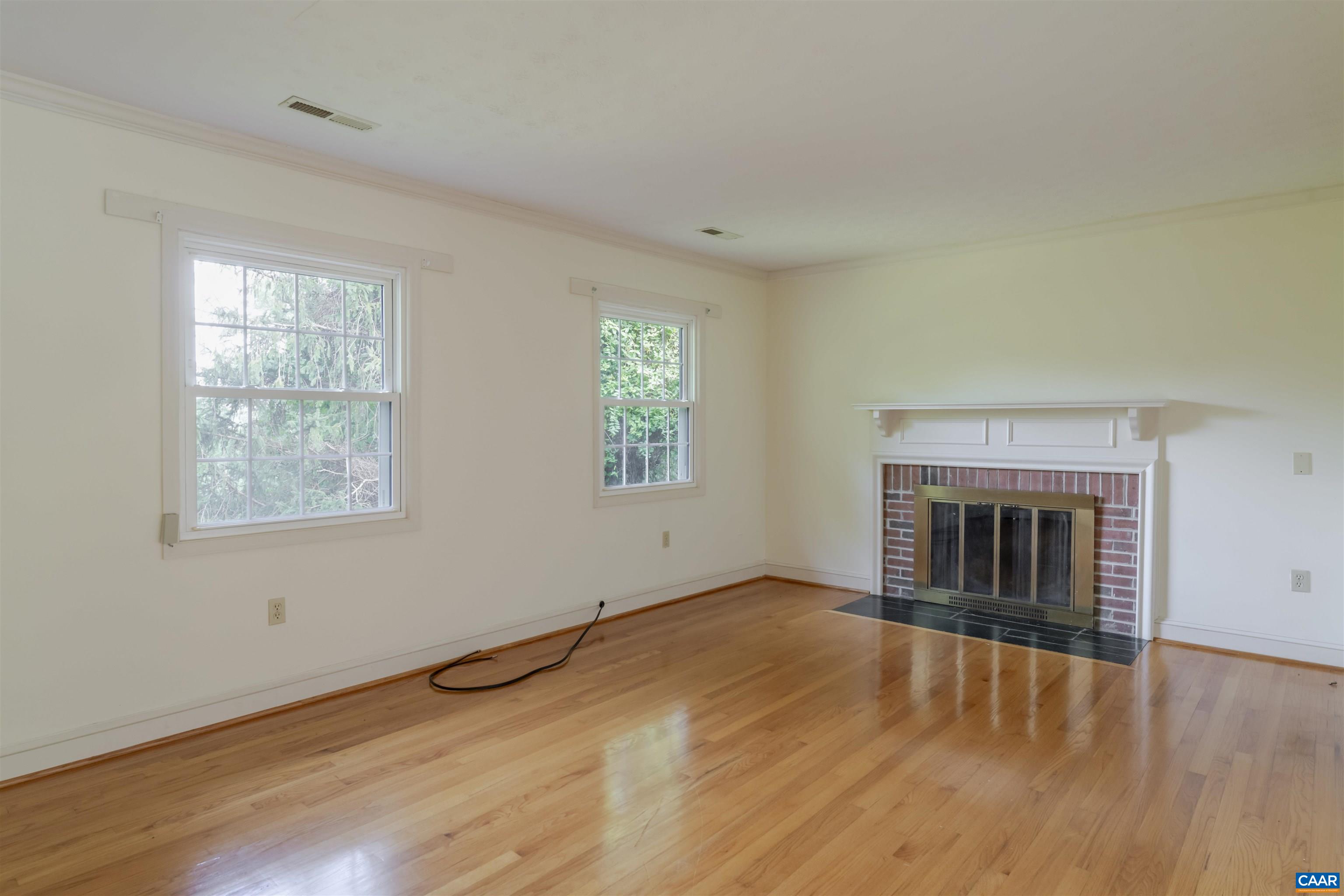 1813 Stony Point Road Charlottesville, VA 22911 - Photo 8 of 40 an empty room with wooden floor fireplace and windows