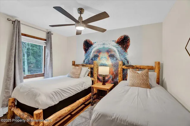 a bedroom with a bed a window and a chandelier