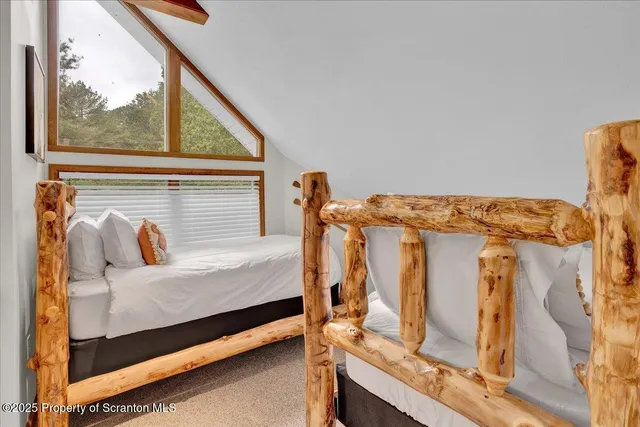 a view of a bedroom with furniture and the window