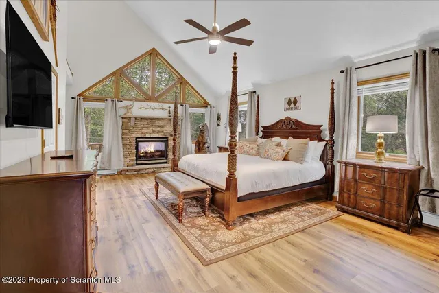 a bedroom with a bed a flat screen tv and balcony