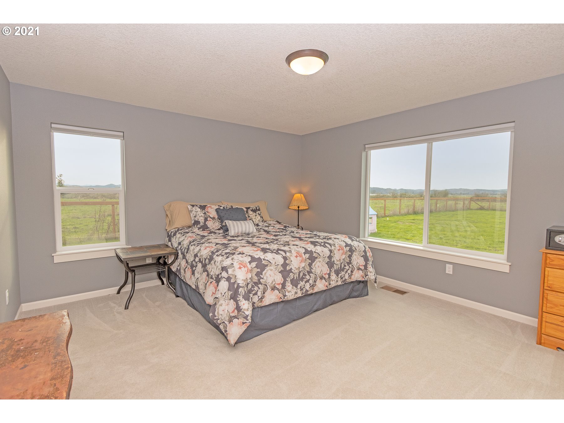 1200 McCormick Loop Road Tillamook, OR 97141 - Photo 22 of 32 a bedroom with a bed and a large window