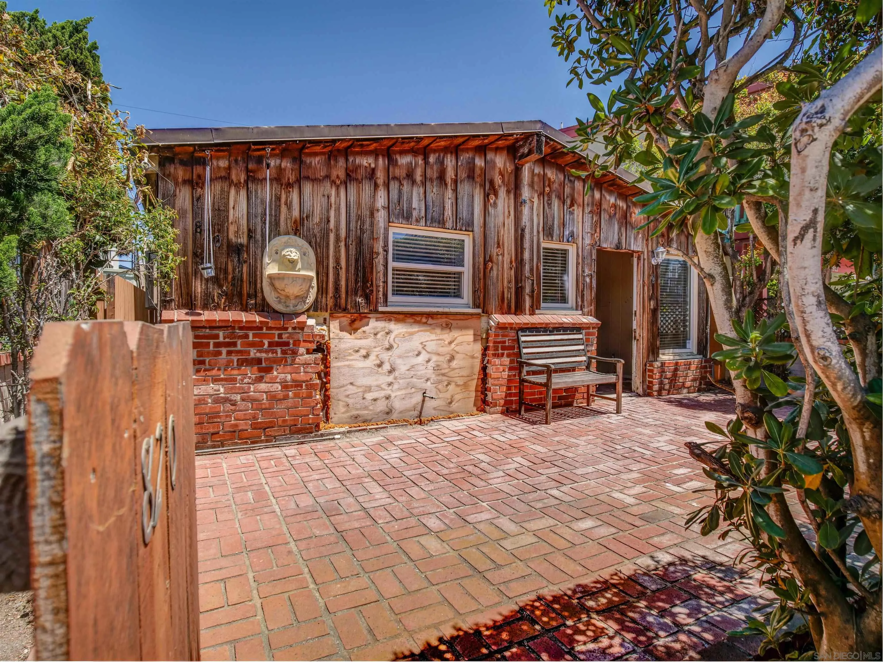 818-820 San Luis Rey Place San Diego, CA 92109 - Photo 3 of 40 a front view of a house with garden
