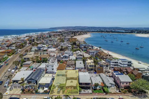 an aerial view of a city with ocean view