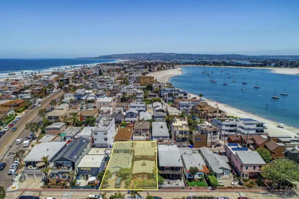 an aerial view of a city with ocean view